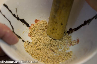 Crush 1 teaspoon toasted white sesame seeds for seaweed salad
