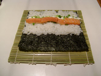 Adding smoked salmon to chumaki roll