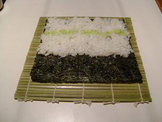 Spreading wasabi on rice for chumaki roll