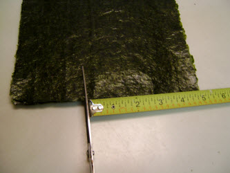 Measuring 5 inches on 8 inch side and cutting the nori sheet down to 5x7