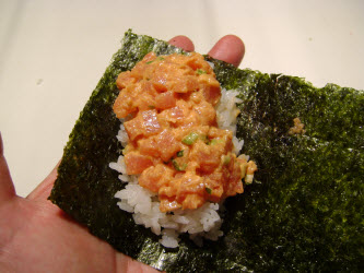 Adding spicy tuna to hand roll