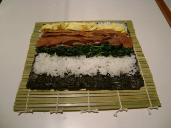 Adding tamago to sushi rice