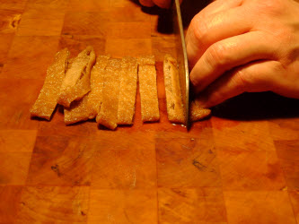 Slicing up seasoned abura age or inarizushi-no-moto for futomaki