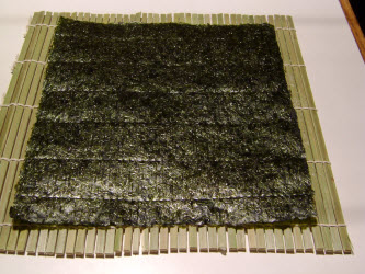 Full sheet of nori on sushi mat (makisu)