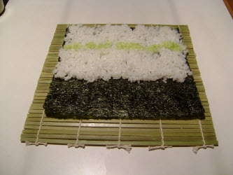 Swiping a row of wasabi across sushi rice