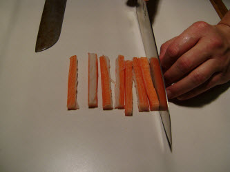 Slicing crab meat stick in half