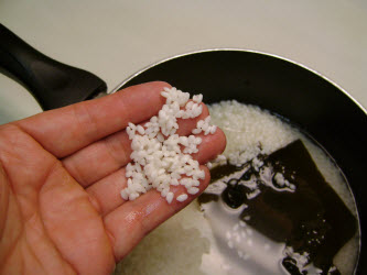 Checking to see if rice has turned "white" after soaking...if it is, then its ready to cook
