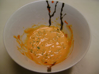 Mixed ingredients for spicy tuna sauce. Mayonaisse, hot sesame oil, Sriracha Hot Chili Sauce, and green onions