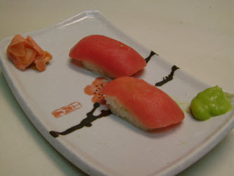 Two nigiri on a sushi plate just like they came out of the Sushi Magic nigiri mold