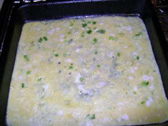 Pour thin layer of tamago egg mixture into pan