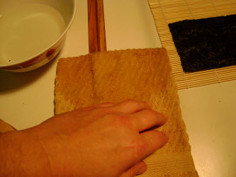 Tap fingers on towel to remove excess vinegared water...