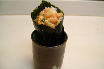 Spicy tuna hand roll in a tea cup