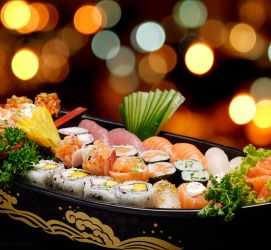 Sushi in a sushi boat with colorful lights in the background