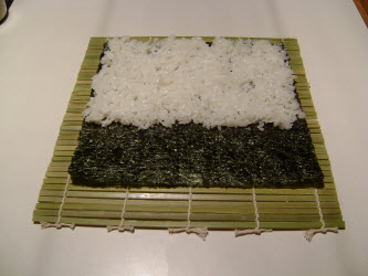 Sushi rice spread on nori for chumaki roll