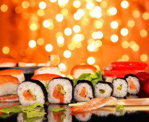 Maki Sushi on black table with fireworks in the background