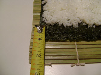 Showing 1 inch strip of bare nori on side farthest away from you