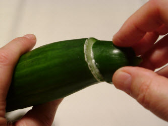Taking the bitterness out of an English cucumber by rubbing the end in a circular motion with the tip