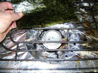 Passing nori sheet over stove eye set on low to make it crispy again...