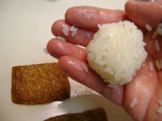 Dip fingers in cooled inari seasoning juice and then form a golf ball size sushi rice ball