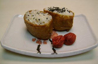 Inari sushi with umeboshi on a white sushi plate