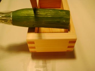 Measuring and cutting to the length the japanese or english cucumber based on the width of the oshibako