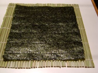 Full sheet on nori on sushi mat makisu