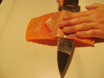 Removing outer brown layer from salmon
