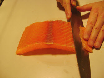 Slicing premium scottish salmon 1/8 inch thick at 45 degree angle for nigiri or sashimi