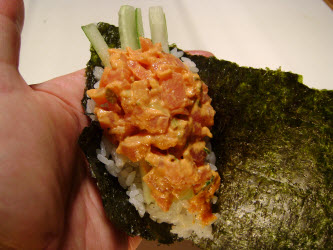 Adding spicy tuna to hand roll