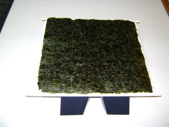 Lay a full sheet of nori on the mat...