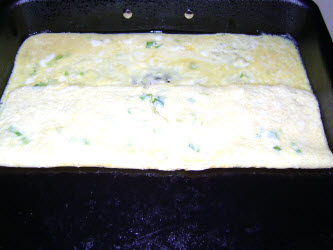Fold over 1/3 of egg mixture in pan