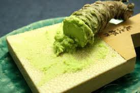 Grinding wasabi root on a sharkskin grinder