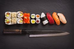 Sashimi knife with different kinds of maki sushi
